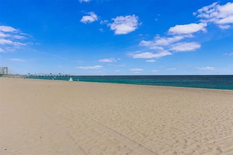 The beach across Briny Avenue, empty sand and the Atlantic beyond.
